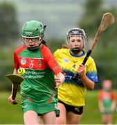 25 August 2024; Megan O'Connor of Inniskeen, Monaghan, in action against Amy Travers of Clarecastle-Ballyea, Clare, right, in the Camogie U14 & O10 Girls during the Cairn Community Games National Outdoor Teams Finals at SETU Pitches and Running Track in Carlow. Photo by Piaras Ó Mídheach/Sportsfile