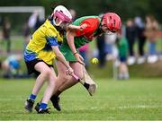 25 August 2024; Lucy Geraghty of Inniskeen, Monaghan, in action against Róisín McDonnell of Clarecastle-Ballyea, Clare, left, in the Camogie U14 & O10 Girls during the Cairn Community Games National Outdoor Teams Finals at SETU Pitches and Running Track in Carlow. Photo by Piaras Ó Mídheach/Sportsfile