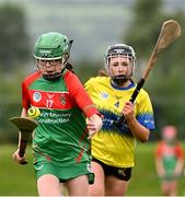 25 August 2024; Megan O'Connor of Inniskeen, Monaghan, in action against Amy Travers of Clarecastle-Ballyea, Clare, right, in the Camogie U14 & O10 Girls during the Cairn Community Games National Outdoor Teams Finals at SETU Pitches and Running Track in Carlow. Photo by Piaras Ó Mídheach/Sportsfile