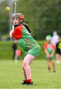 25 August 2024; Shannan Hillard of Inniskeen, Monaghan, in action against Clarecastle-Ballyea, Clare, in the Camogie U14 & O10 Girls during the Cairn Community Games National Outdoor Teams Finals at SETU Pitches and Running Track in Carlow. Photo by Piaras Ó Mídheach/Sportsfile