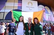 1 September 2024; Eve McCrystal of Ireland, centre, celebrates with daughters Ava, left, and Nessa after winning silver in the women's B 3000m individual pursuit final on day four of the Paris 2024 Paralympic Games at Vélodrome de Saint-Quentin-en-Yvelines in Paris, France. Photo by Harry Murphy/Sportsfile