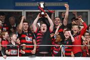 1 September 2024; Ballygunner supporter Tom Mullane lifts the Waterford News and Star Cup, alongside joint captains Conor Sheahan, left, and Pauric Mahony, after his side's victory in  the Waterford Senior Club Hurling Championship Final match between Abbeyside Ballinacourty and Ballygunner at Fraher Field in Dungarvan, Waterford. Photo by Seb Daly/Sportsfile