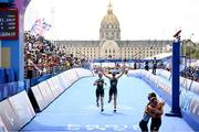 2 September 2024; Judith MacCombe, right, and guide Eimear Nicholls of Ireland cross the line to finish in eighth place during the women's PTVI race on day five of the Paris 2024 Paralympic Games at Pont Alexandre III in Paris, France. Photo by Ramsey Cardy/Sportsfile