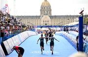2 September 2024; Judith MacCombe, right, and guide Eimear Nicholls of Ireland cross the line to finish in eighth place during the women's PTVI race on day five of the Paris 2024 Paralympic Games at Pont Alexandre III in Paris, France. Photo by Ramsey Cardy/Sportsfile