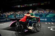 2 September 2024; Colin Judge of Ireland, right, embraces winner Feng Panfeng of China after the men's singles MS11 round of 16 match on day five of the Paris 2024 Paralympic Games at South Paris Arena in Paris, France. Photo by Harry Murphy/Sportsfile