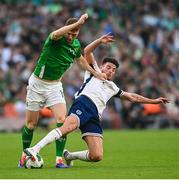 7 September 2024; Jake O'Brien of Republic of Ireland is tackled by Declan Rice of England during the UEFA Nations League B match between Republic of Ireland and England at Aviva Stadium in Dublin. Photo by David Fitzgerald/Sportsfile