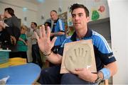 23 September 2013; Michael Darragh MacAuley has his hand cast which will be auctioned in aid of Our Lady's Hospital for Sick Children, Crumlin, on a visit by the All-Ireland Senior Football Champions to Our Lady's Hospital for Sick Children, Crumlin. Picture credit: Brian Lawless / SPORTSFILE