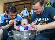 23 September 2013; Dublin's Michael Darragh MacAuley with Sadhbh Down, age 9 months, from Drimnagh, and her dad Derkin Down with the Sam Maguire cup on a visit by the All-Ireland Senior Football Champions to Our Lady's Hospital for Sick Children, Crumlin. Picture credit: Brian Lawless / SPORTSFILE