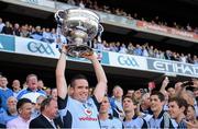 22 September 2013; Dublin's Ger Brennan lifts the Sam Maguire Cup after the game. GAA Football All-Ireland Senior Championship Final, Dublin v Mayo, Croke Park, Dublin. Picture credit: Ray McManus / SPORTSFILE