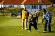 11 September 2024; Padraig Harrington of Ireland, centre, assists an amateur during the Pro Am before the Amgen Irish Open Golf Championship 2024 at the Royal County Down Golf Club in Newcastle, Down. Photo by Brendan Moran/Sportsfile