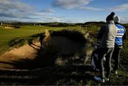12 September 2024; Aaron Rai of England chips out the bunker on the 12th fairway watched by Sebastian Söderberg of Sweden who awaits his turn to play from the same bunker during day one of the Amgen Irish Open Golf Championship 2024 at the Royal County Down Golf Club in Newcastle, Down. Photo by Brendan Moran/Sportsfile