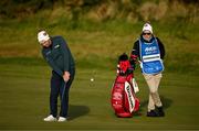 12 September 2024; Padraig Harrington of Ireland chips onto the 13th green watched by caddy Ronan Flood during day one of the Amgen Irish Open Golf Championship 2024 at the Royal County Down Golf Club in Newcastle, Down. Photo by Brendan Moran/Sportsfile