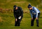 13 September 2024; Shane Lowry of Ireland and his caddie Darren Reynolds check their lie at the 17th  green during day two of the Amgen Irish Open Golf Championship 2024 at the Royal County Down Golf Club in Newcastle, Down. Photo by Brendan Moran/Sportsfile