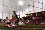 14 September 2024; Danny Mullen of Derry City scores his side's second goal despite the tackle of Sam Bone of Shelbourne during the Sports Direct Men's FAI Cup Quarter Final match between Derry City and Shelbourne at the The Ryan McBride Brandywell Stadium in Derry. Photo by Ben McShane/Sportsfile