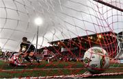 14 September 2024; Danny Mullen of Derry City scores his side's second goal despite the tackle of Sam Bone of Shelbourne during the Sports Direct Men's FAI Cup Quarter Final match between Derry City and Shelbourne at the The Ryan McBride Brandywell Stadium in Derry. Photo by Ben McShane/Sportsfile