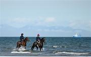 16 September 2024; Race horses and riders in the surf before the Laytown Races in Laytown, Meath. Photo by Ramsey Cardy/Sportsfile