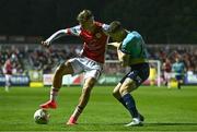 20 September 2024; Mason Melia of St Patrick's Athletic in action against Darragh Leahy of Waterford during the SSE Airtricity Men's Premier Division match between St Patrick's Athletic and Waterford at Richmond Park in Dublin. Photo by Shauna Clinton/Sportsfile