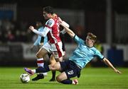 20 September 2024; Kian Leavy of St Patrick's Athletic is tackled by Harvey Macadam of Waterford during the SSE Airtricity Men's Premier Division match between St Patrick's Athletic and Waterford at Richmond Park in Dublin. Photo by Shauna Clinton/Sportsfile
