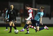 20 September 2024; Kian Leavy of St Patrick's Athletic is tackled by Harvey Macadam of Waterford during the SSE Airtricity Men's Premier Division match between St Patrick's Athletic and Waterford at Richmond Park in Dublin. Photo by Shauna Clinton/Sportsfile