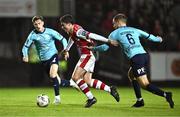 20 September 2024; Kian Leavy of St Patrick's Athletic in action against Rowan McDonald of Waterford during the SSE Airtricity Men's Premier Division match between St Patrick's Athletic and Waterford at Richmond Park in Dublin. Photo by Shauna Clinton/Sportsfile