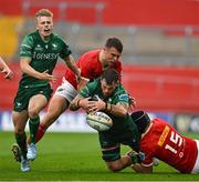 21 September 2024; Conor Oliver of Connacht is tackled by Tom Farrell and Mike Haley of Munster during the United Rugby Championship match between Munster and Connacht at Thomond Park in Limerick. Photo by Brendan Moran/Sportsfile