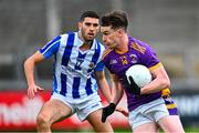 21 September 2024; Dara Mullin of Kilmacud Crokes in action against Evan Nugent of Ballyboden St Endas during the Dublin County Senior 1 Club Football Championship quarter-final match between Kilmacud Crokes and Ballyboden St Endas at Parnell Park in Dublin. Photo by Shauna Clinton/Sportsfile