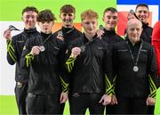 21 September 2024; The Ireland team, from left, Oisin O'Connell, Michael Carson, Michael O'Neill, Niall Hooton, James Hickey, coach Sergey Sizhanov and Adam Steele after winning silver in the men's all-around event during day one of the Gymnastics Ireland hosted Northern European Championships 2024 at the National Indoor Arena on the Sport Ireland Campus in Dublin. Photo by Stephen McCarthy/Sportsfile