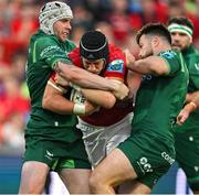 21 September 2024; Mike Haley of Munster is tackled by Mack Hansen and Dylan Tierney-Martin of Connacht during the United Rugby Championship match between Munster and Connacht at Thomond Park in Limerick. Photo by Brendan Moran/Sportsfile