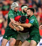 21 September 2024; Mike Haley of Munster is tackled by Mack Hansen and Dylan Tierney-Martin of Connacht during the United Rugby Championship match between Munster and Connacht at Thomond Park in Limerick. Photo by Brendan Moran/Sportsfile