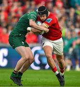 21 September 2024; Mike Haley of Munster is tackled by Mack Hansen of Connacht during the United Rugby Championship match between Munster and Connacht at Thomond Park in Limerick. Photo by Brendan Moran/Sportsfile