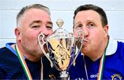 22 September 2024; Munster managers Dave Fitzgerald, left, and John Carey kiss the trophy after their side's victory in the 2024 M. Donnelly GAA Wheelchair Hurling / Camogie All-Ireland Finals final match between Leinster and Munster at SETU Carlow Campus Sports Hall in Carlow. Photo by Shauna Clinton/Sportsfile
