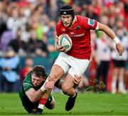21 September 2024; Mike Haley of Munster is tackled by Cathal Forde of Connacht during the United Rugby Championship match between Munster and Connacht at Thomond Park in Limerick. Photo by Brendan Moran/Sportsfile