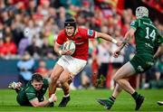 21 September 2024; Mike Haley of Munster is tackled by Cathal Forde of Connacht during the United Rugby Championship match between Munster and Connacht at Thomond Park in Limerick. Photo by Brendan Moran/Sportsfile