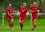 28 September 2024; Nia Lewis of Cymru, centre, celebrates with team-mates after scoring her side's first goal during the women's U17 international friendly match between Republic of Ireland and Cymru at the AUL Complex in Clonsaugh, Dublin. Photo by Shauna Clinton/Sportsfile