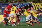 28 September 2024; Tom Farrell of Munster in action against Luca Rizzoli, left, and Matteo Canali of Zebre Parma during the United Rugby Championship match between Zebre Parma and Munster at Stadio Sergio Lanfranchi in Parma, Italy. Photo by Roberto Bregani/Sportsfile