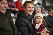 28 September 2024; Kieran O'Connor, husband of Galway United's Julie-Ann Russell, and their daughter Rosie watch on during the SSE Airtricity Women's Premier Division match between Galway United and Shelbourne at Eamonn Deacy Park in Galway. Photo by Stephen McCarthy/Sportsfile