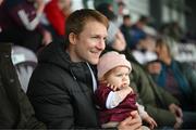 28 September 2024; Kieran O'Connor, husband of Galway United's Julie-Ann Russell, and their daughter Rosie watch on during the SSE Airtricity Women's Premier Division match between Galway United and Shelbourne at Eamonn Deacy Park in Galway. Photo by Stephen McCarthy/Sportsfile