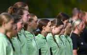 28 September 2024; Republic of Ireland players, including Ava Mullins, centre, stand for the national anthem before the women's U17 international friendly match between Republic of Ireland and Cymru at the AUL Complex in Clonsaugh, Dublin. Photo by Shauna Clinton/Sportsfile