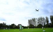 28 September 2024; An airplane flies overhead as Republic of Ireland players warm-up before the women's U17 international friendly match between Republic of Ireland and Cymru at the AUL Complex in Clonsaugh, Dublin. Photo by Shauna Clinton/Sportsfile