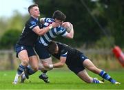 29 September 2024; Harry Casey of Blackrock is tackled by Fearghal Carr, left, and Joseph Smyth of Corinthians during the Bank of Ireland JP Fanagan Premier 1 qualifiers final match between Corinthians RFC and Blackrock College RFC at Corinthians RFC in Galway. Photo by Shauna Clinton/Sportsfile