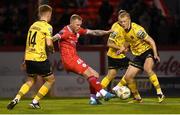 30 September 2024; Aiden O'Brien of Shelbourne has a shot on goal despite the efforts of Brandon Kavanagh, left, and Tom Grivosti of St Patrick's Athletic during the SSE Airtricity Men's Premier Division match between Shelbourne and St Patrick's Athletic at Tolka Park in Dublin. Photo by Stephen McCarthy/Sportsfile