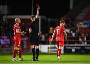 30 September 2024; Matty Smith of Shelbourne is shown a red card by referee Damien MacGraith during the SSE Airtricity Men's Premier Division match between Shelbourne and St Patrick's Athletic at Tolka Park in Dublin. Photo by Stephen McCarthy/Sportsfile
