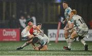 5 October 2024; Mike Haley of Munster is tackled by Max Nagy of Ospreys during the United Rugby Championship match between Munster and Ospreys at Virgin Media Park in Cork. Photo by Seb Daly/Sportsfile