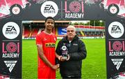6 October 2024; Shelbourne captain Raymond Offor collects the player of the match award on behalf of Dan Ring from LOI Academy Coordinator Pat Duffy after the EA SPORTS MU17 LOI Mark Farren Cup match between Shelbourne and Kerry FC at Tolka Park in Dublin. Photo by Tyler Miller/Sportsfile
