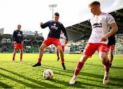 6 October 2024; Daniel Ring of Shelbourne, centre, warms-up alongside teammate Luca Cailloce, right, before the SSE Airtricity Men's Premier Division match between Shamrock Rovers and Shelbourne at Tallaght Stadium in Dublin. Photo by Seb Daly/Sportsfile