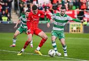6 October 2024; Jack Byrne of Shamrock Rovers scores his side's first goal, despite pressure from Shelbourne's Sean Gannon, during the SSE Airtricity Men's Premier Division match between Shamrock Rovers and Shelbourne at Tallaght Stadium in Dublin. Photo by Seb Daly/Sportsfile