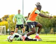 7 October 2024; Festy Ebosele is tackled by Andrew Omobamidele, left, during a Republic of Ireland training session at the FAI National Training Centre in Abbotstown, Dublin. Photo by Stephen McCarthy/Sportsfile