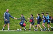 8 October 2024; Oli Jager high fives local schoolchildren on his way to Munster rugby squad training at University of Limerick in Limerick. Photo by Brendan Moran/Sportsfile