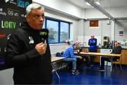 11 October 2024; Hospitality volunteers watch on as Waterford manager Keith Long is interviewed before the SSE Airtricity Men's Premier Division match between Waterford and Drogheda United at the Regional Sports Centre in Waterford. Photo by Tyler Miller/Sportsfile