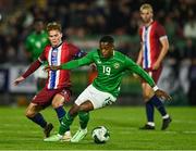 11 October 2024; Aidomo Emakhu of Republic of Ireland in action against Kristian Arnstad of Norway during the UEFA European U21 Championship qualifier match between Republic of Ireland and Norway at Turner's Cross in Cork. Photo by Brendan Moran/Sportsfile